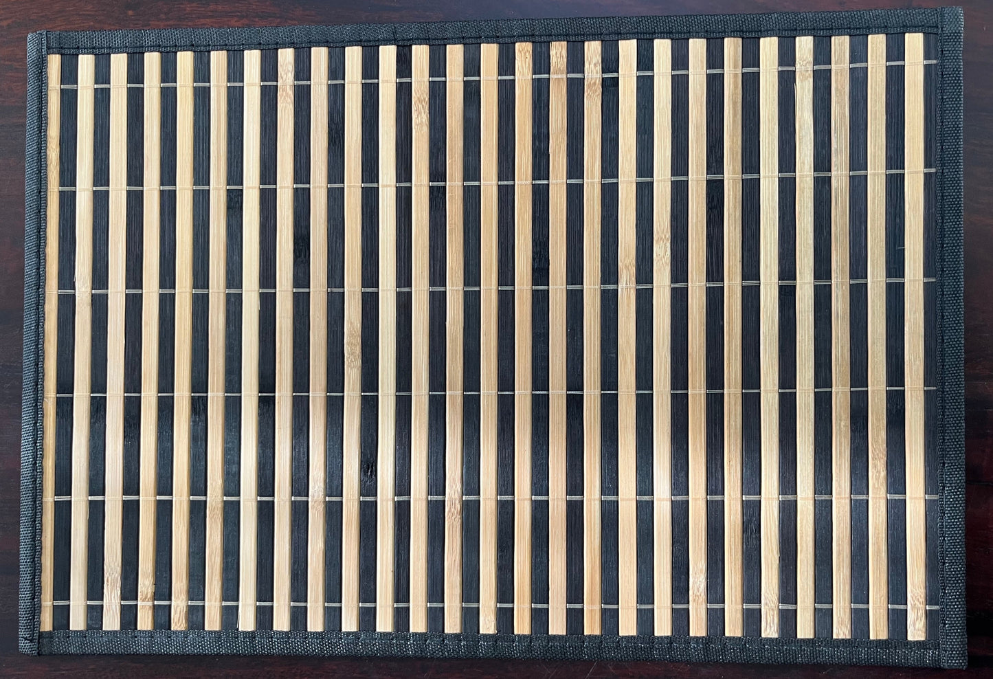 Set of 6 bamboo woven placemats in dark brown with natural stripes, perfect for rustic and eco-friendly dining