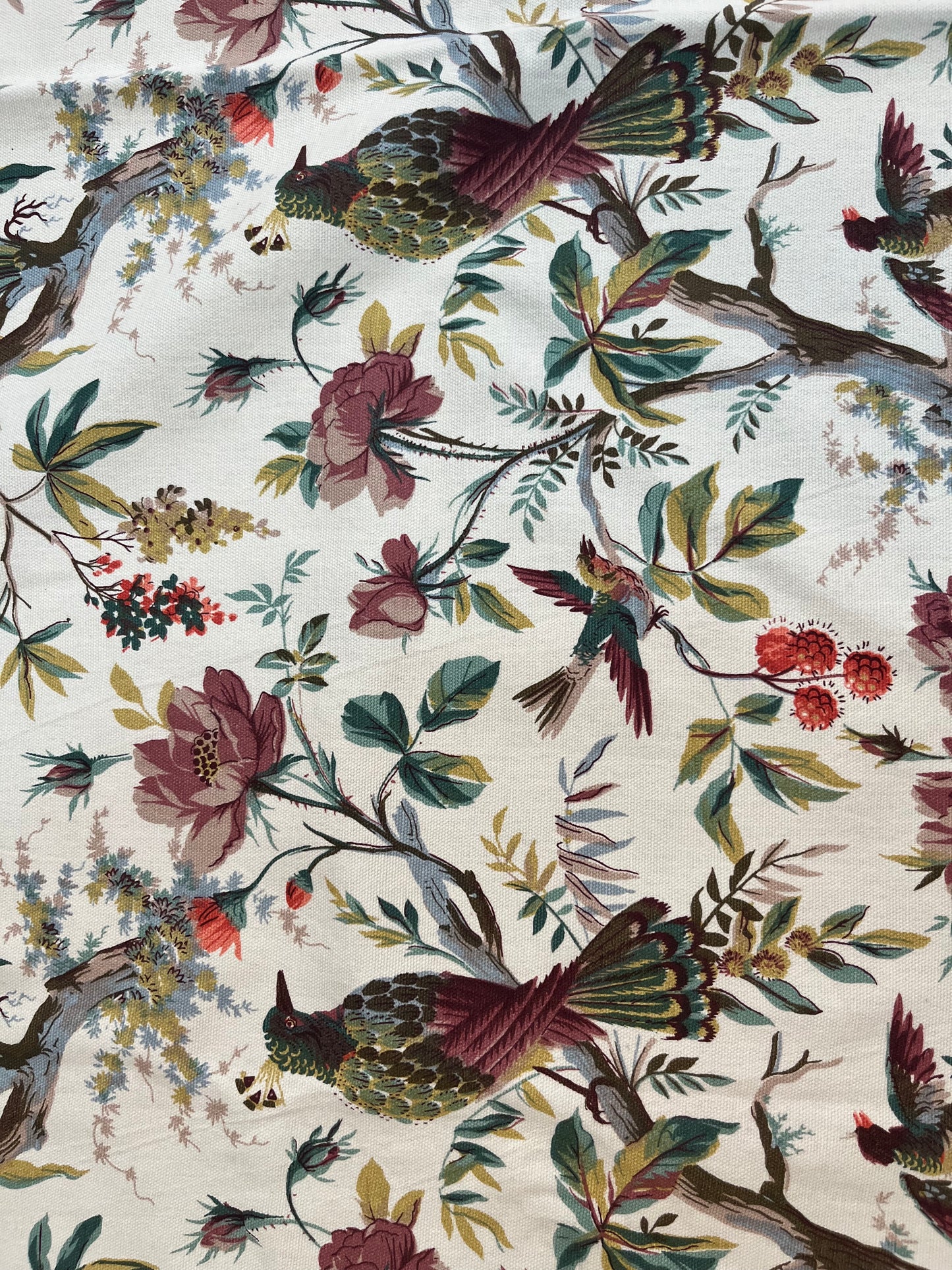 Close-up of cotton dining tablecloth showcasing intricate hummingbird and floral botanical print with soft pastel tones