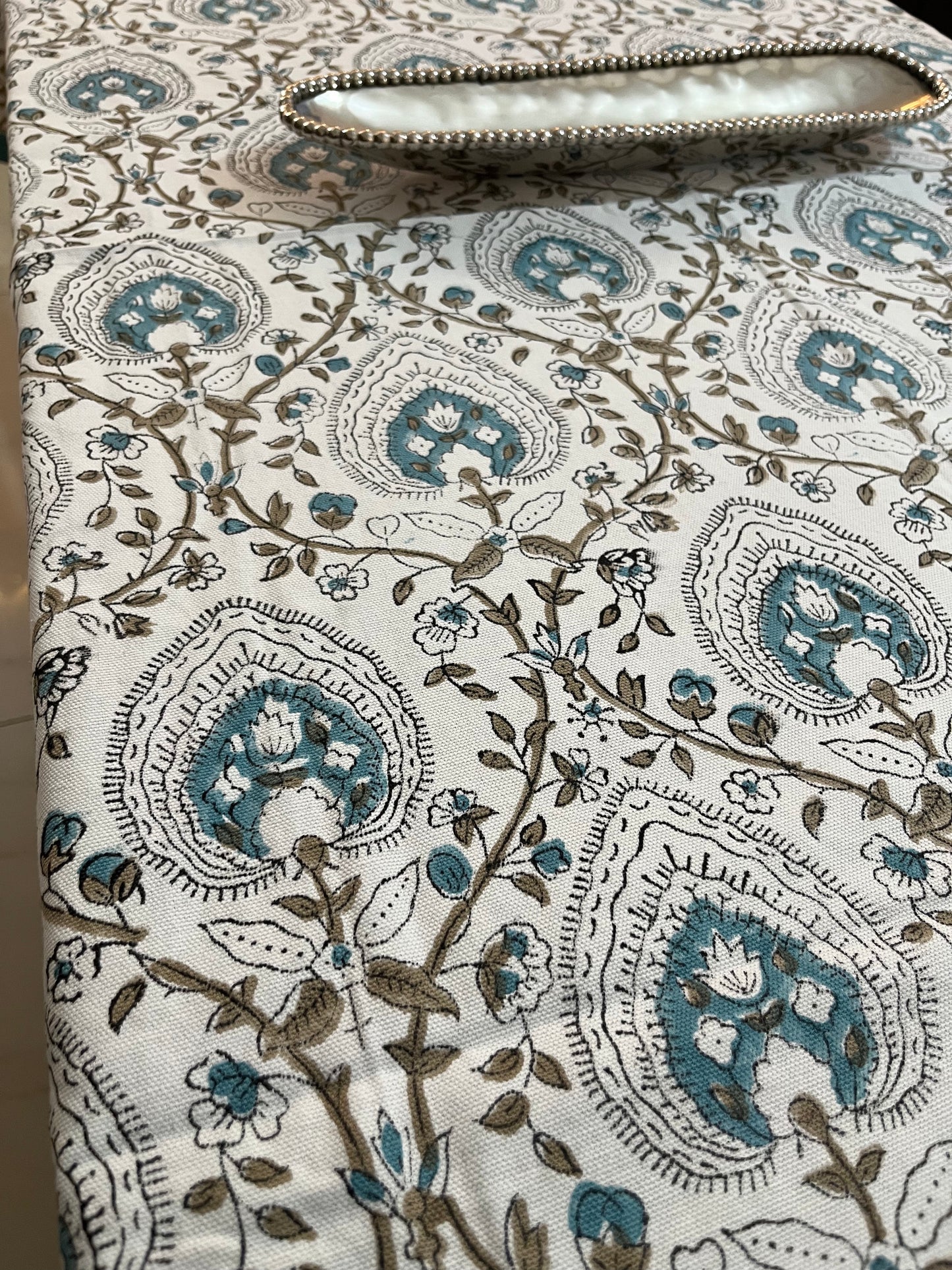 Dining table setup featuring a cotton tablecloth with teal and beige floral and geometric patterns, adding a sophisticated charm