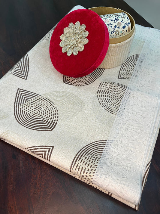 Beautifully styled dining table with an elegant PVC tablecloth featuring a geometric pattern, lace border, and golden, white, and brown design