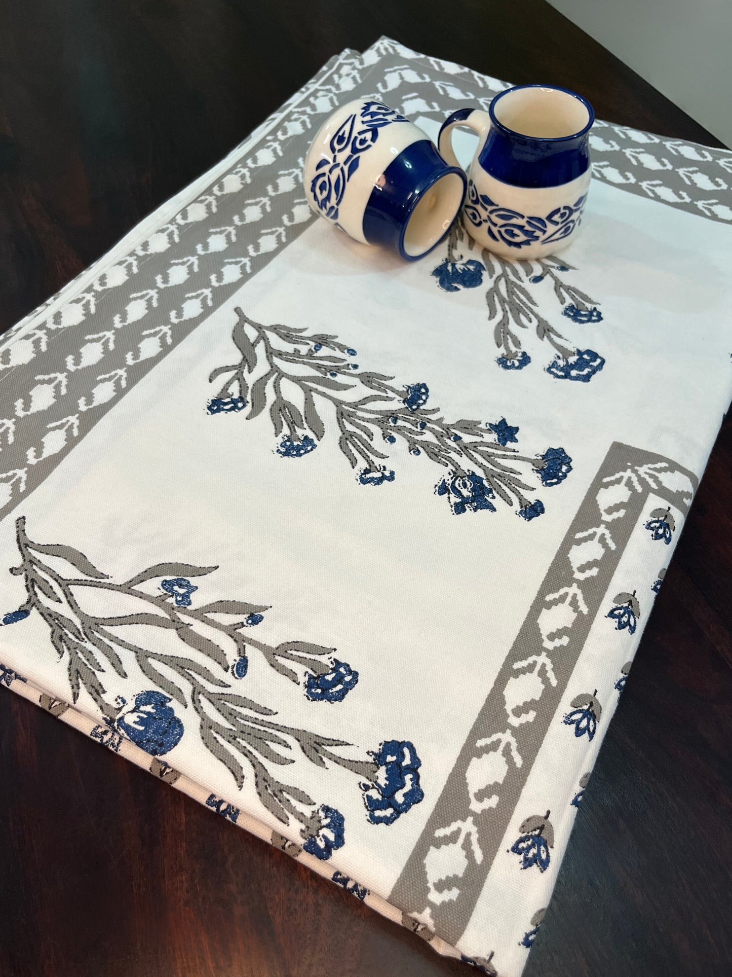 Beautifully styled dining table with a floral block print cotton tablecloth in blue and grey
