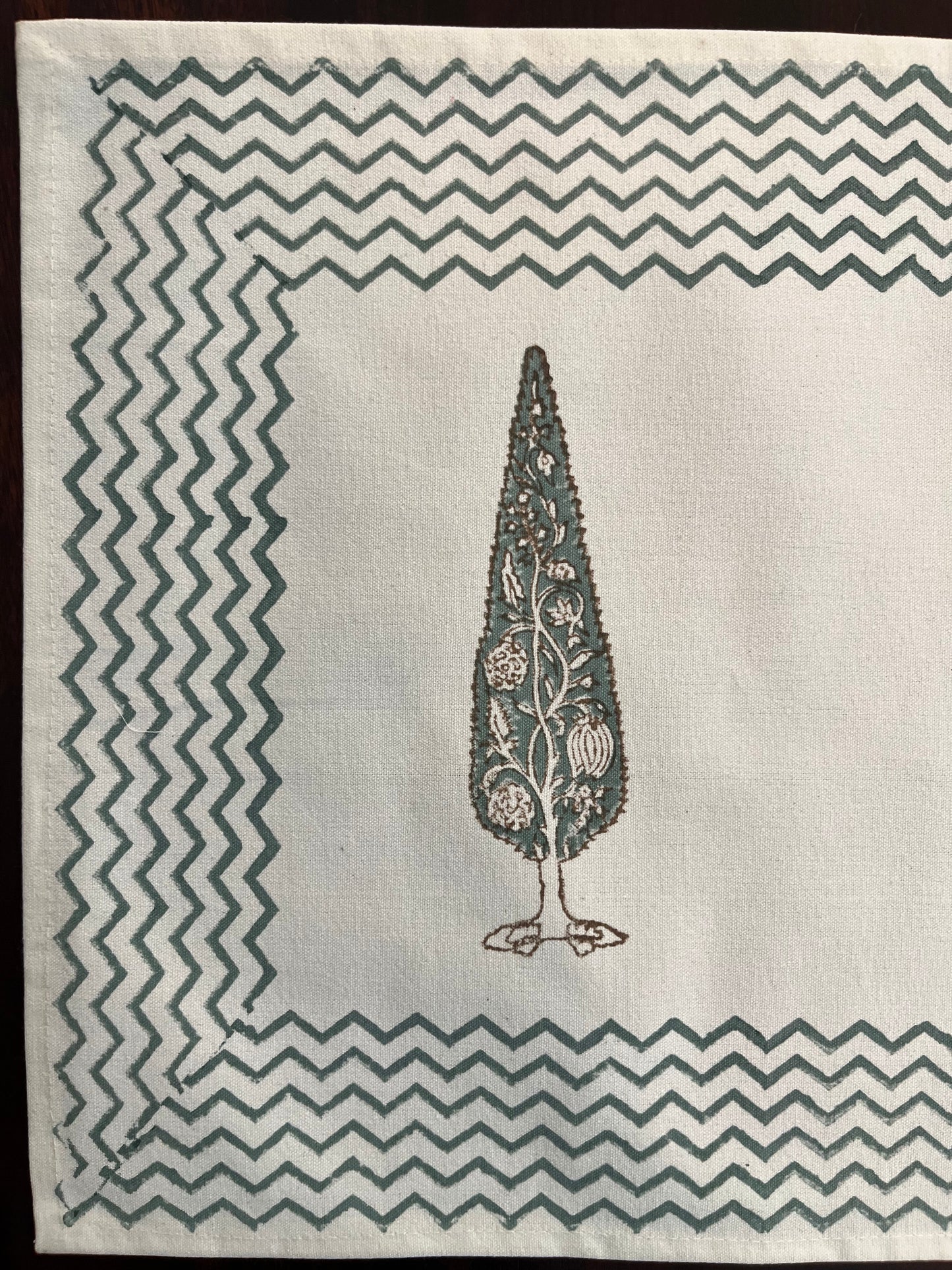 Close-up of block-printed table mat showcasing intricate cypress tree motif with fine detailing