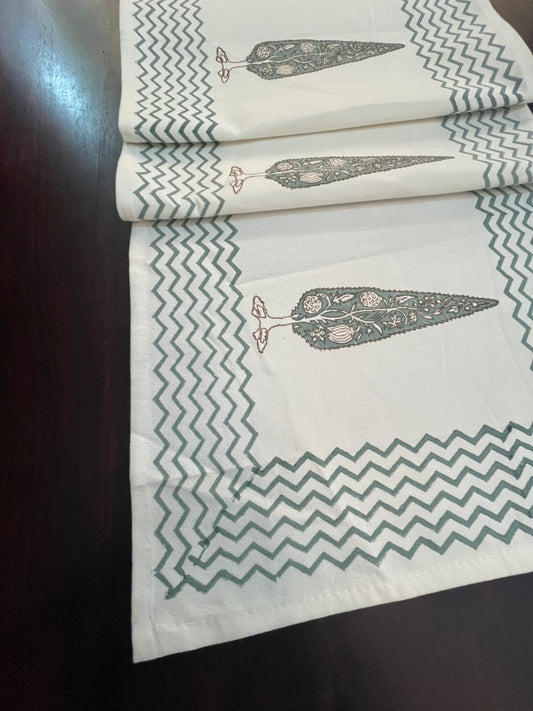 Close-up of decorative table runner showcasing a floral tree print with a stylish chevron border