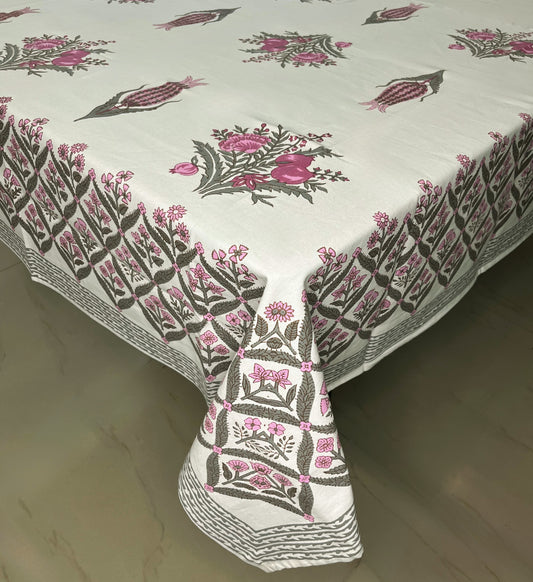Floral block print dining cotton tablecloth with a traditional pink and green design on a white background