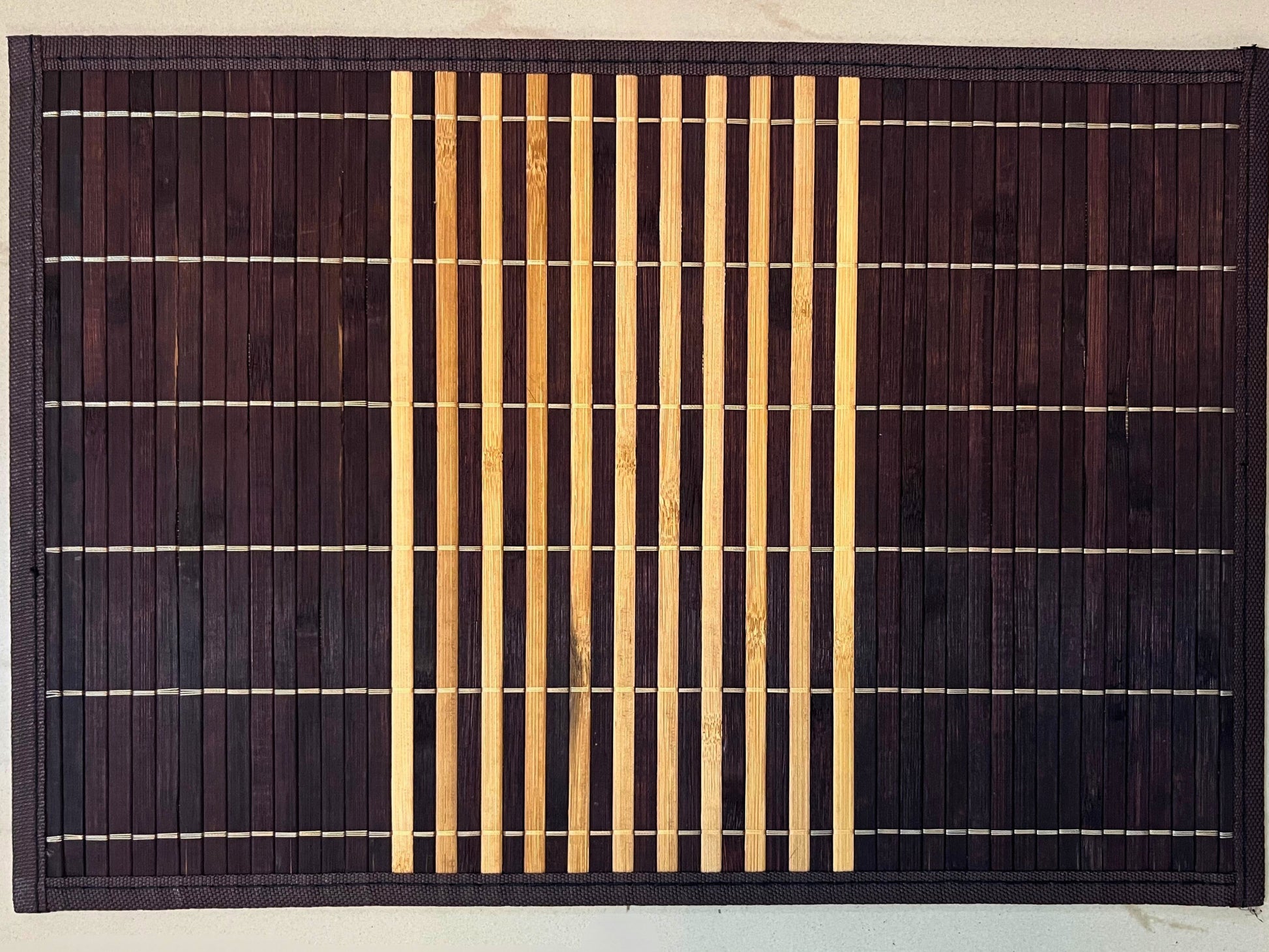 Set of 6 bamboo placemats featuring dark brown and natural horizontal stripes, perfect for an eco-friendly and stylish table setting