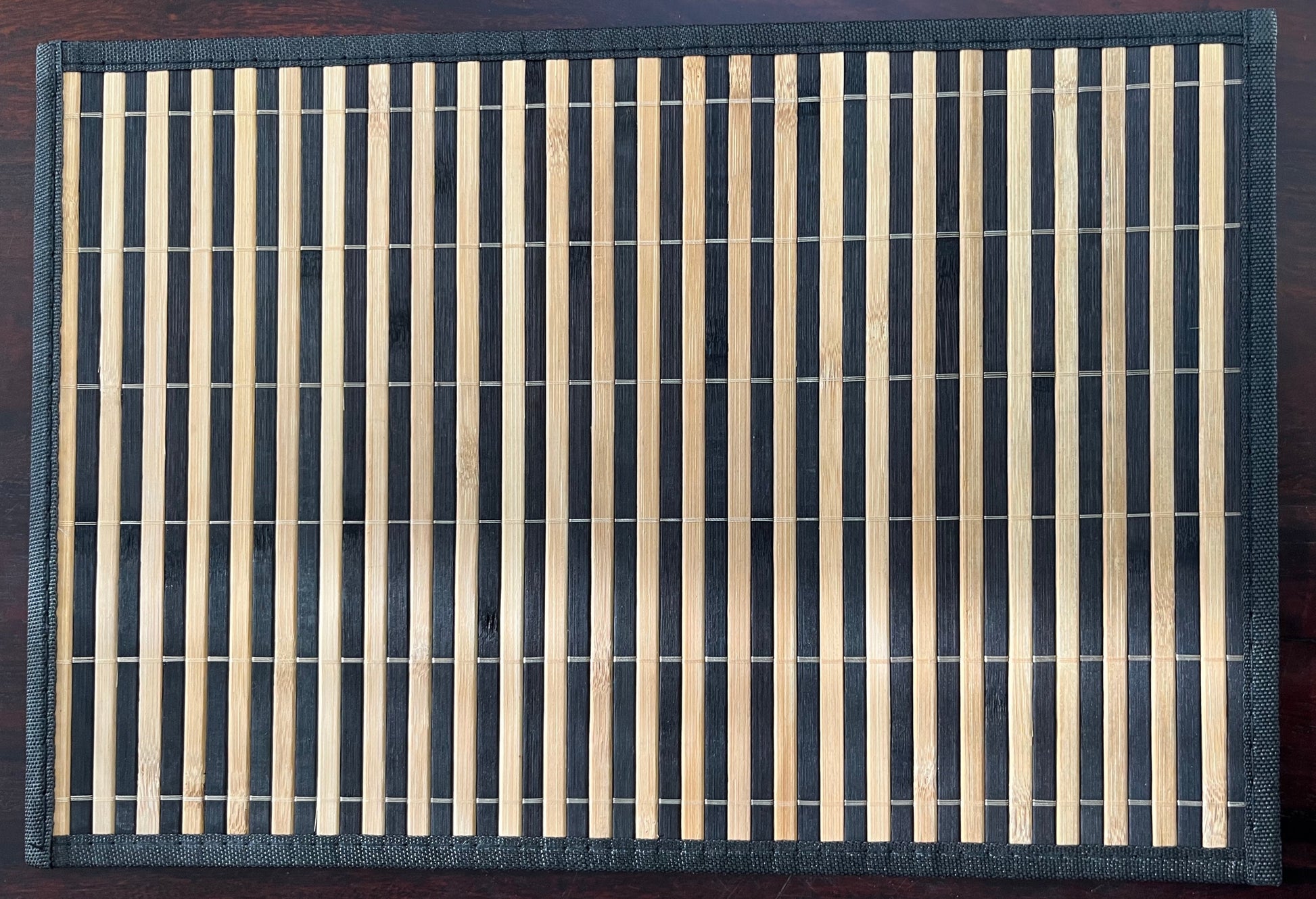 Set of 6 bamboo woven placemats in dark brown with natural stripes, perfect for rustic and eco-friendly dining