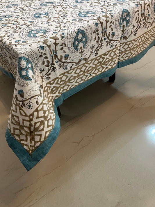 Cotton tablecloth featuring floral and geometric patterns in teal and beige, perfect for a stylish and elegant dining setup