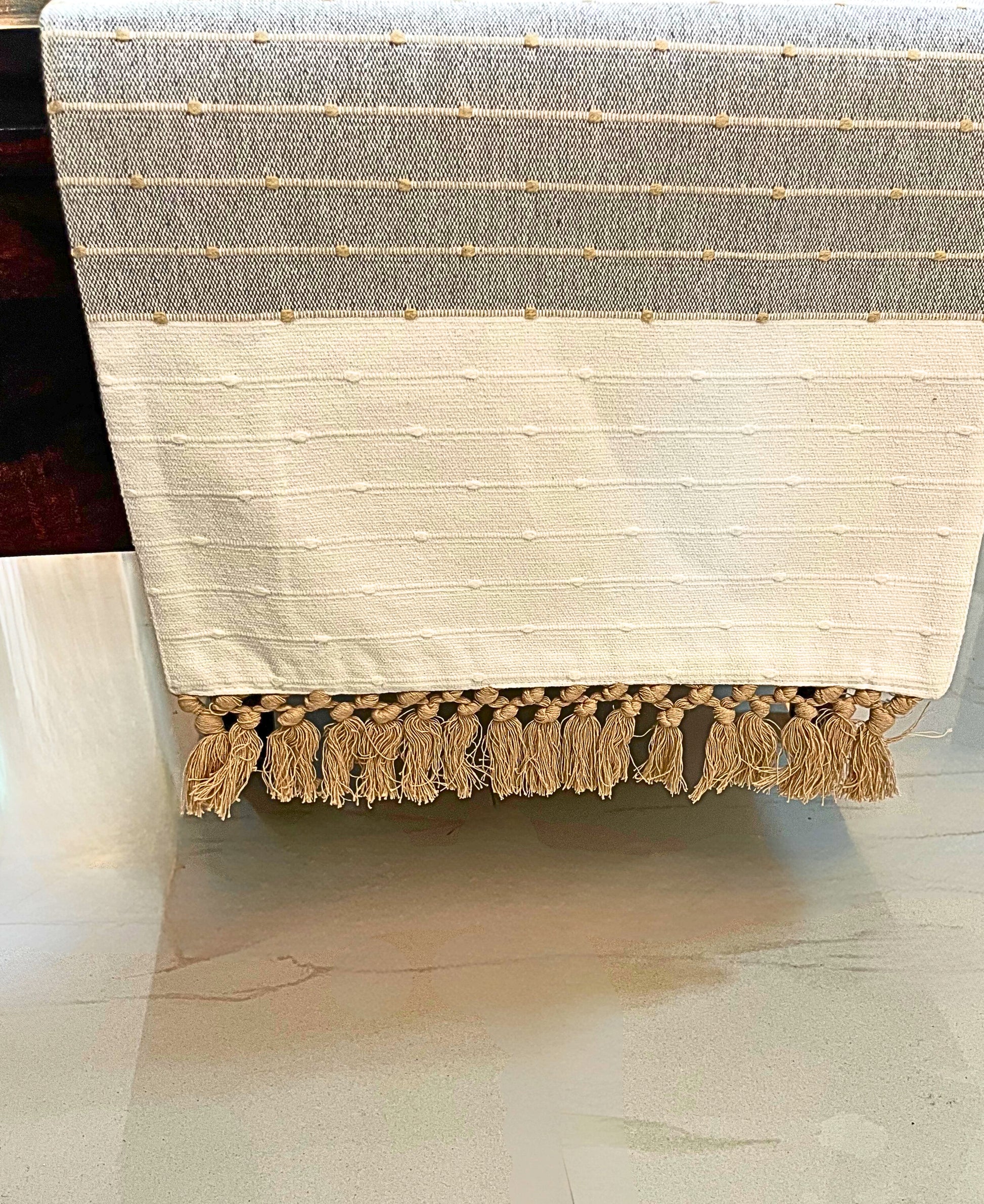 Decorative table runner featuring an elegant tassel design with embroidery in gray and white