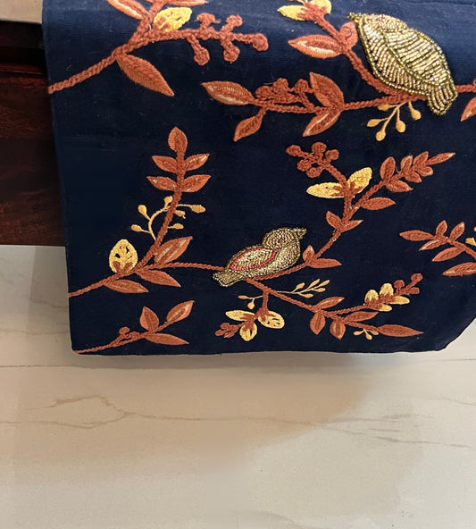 Decorative table runner featuring embroidered and beaded birds and leaves for an elegant look
