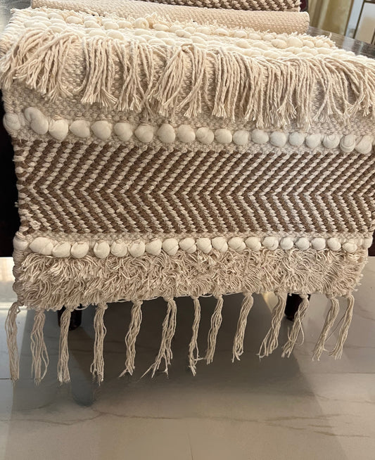 Decorative table runner featuring playful pom poms and tassels for a stylish look