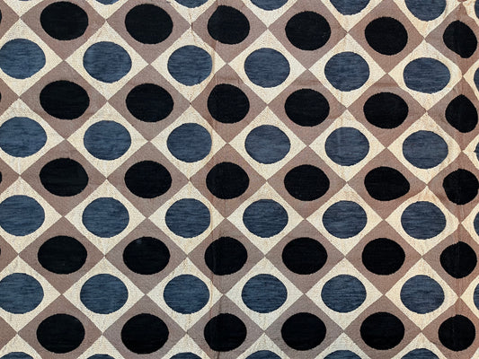 Close-up of premium jacquard table cover showcasing intricate polka dot pattern in navy blue and brown on a luxurious fabric