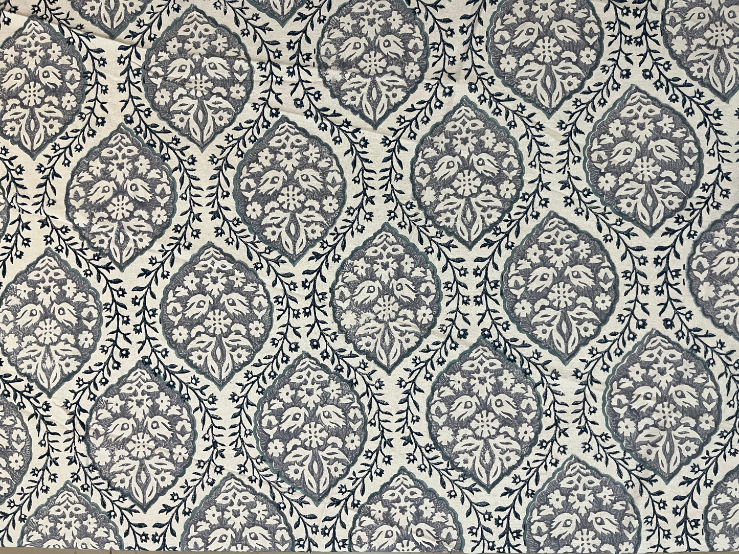 Close-up of round table cover showcasing soft fabric texture and refined grey and white pattern for a classic look
