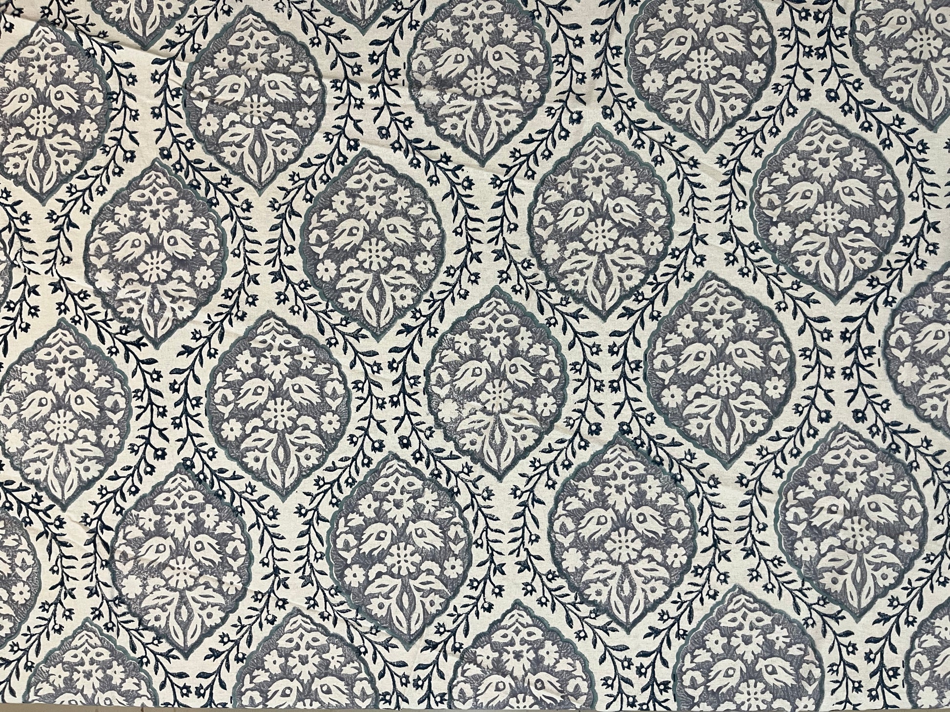 Close-up of round table cover showcasing soft fabric texture and refined grey and white pattern for a classic look