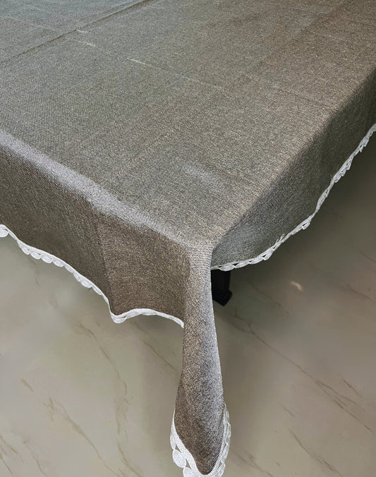 Elegant dining table cover with lace trim, grey textured fabric, and a decorative scalloped white border