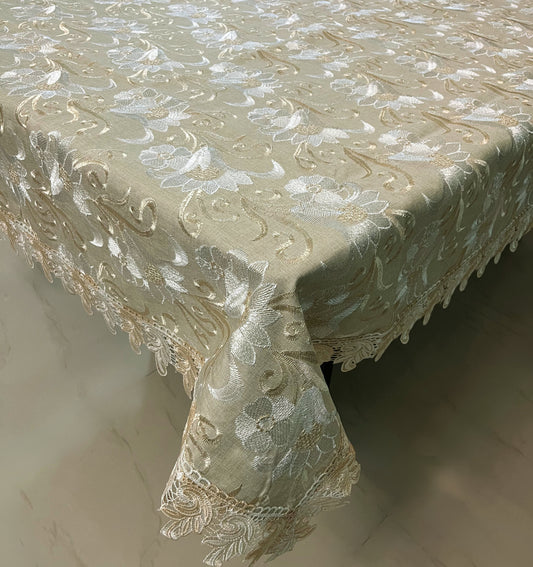 Elegant lace dining tablecloth with floral embroidery in gold and white, featuring a scalloped border