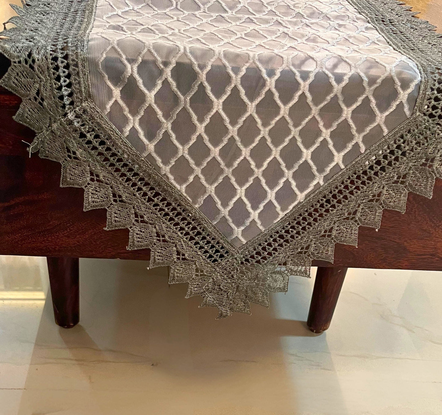 Elegant lace table runner featuring a grey diamond pattern with a decorative crochet border