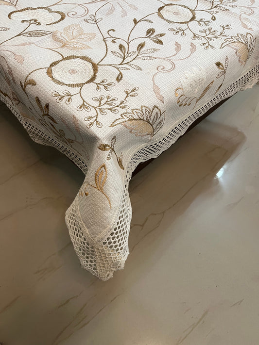 Embroidered taupe table cover featuring elegant paisley and floral motifs, perfect for adding a refined touch to any dining space