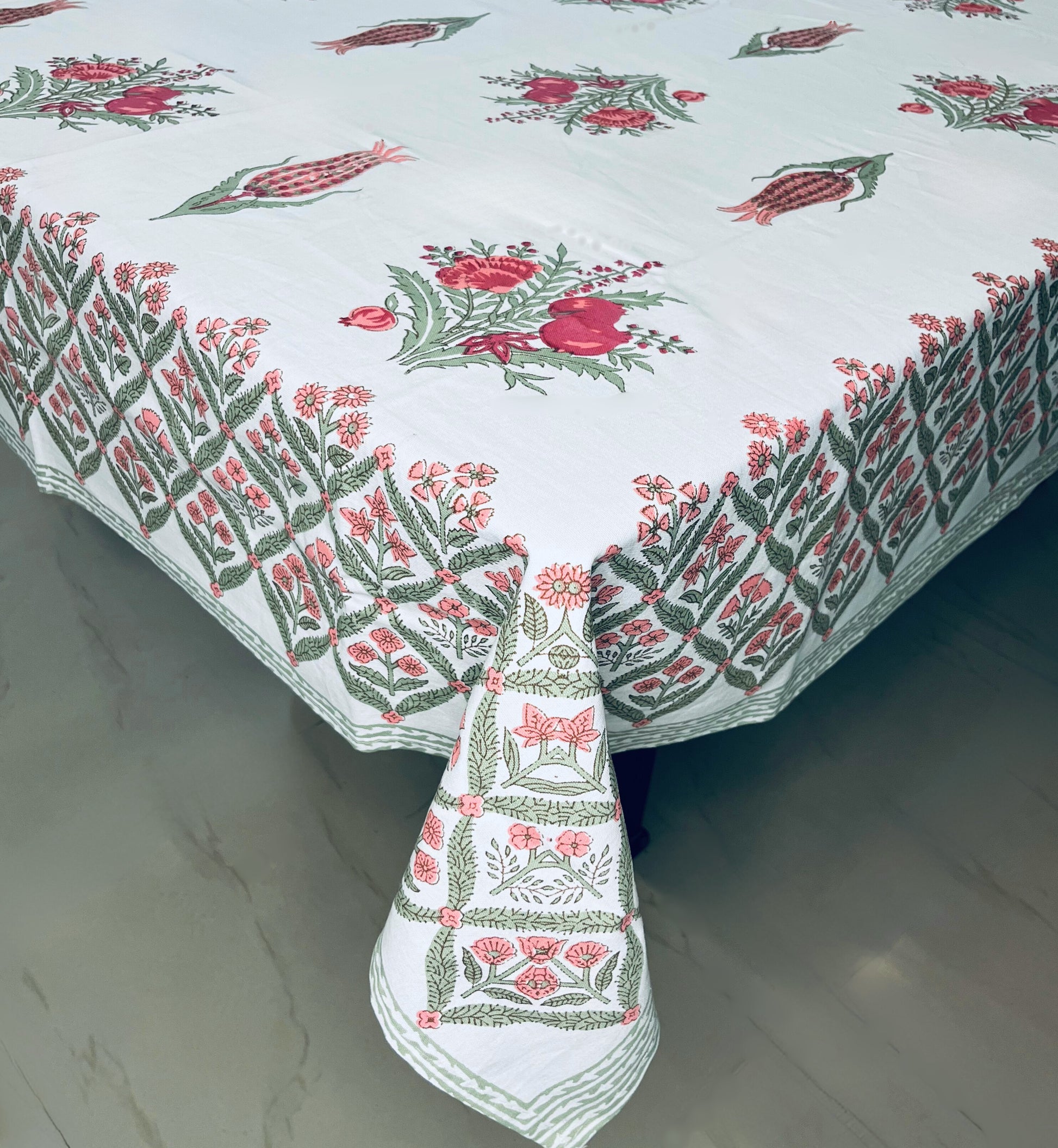 Floral block print dining cotton tablecloth with a traditional red and green design on a white background
