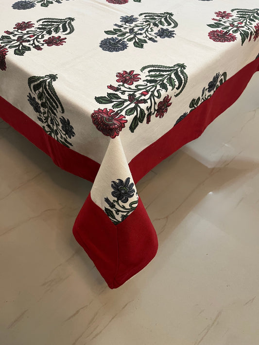 Floral block print tablecloth featuring burgundy and forest green motifs, adding a traditional and elegant touch to any dining space
