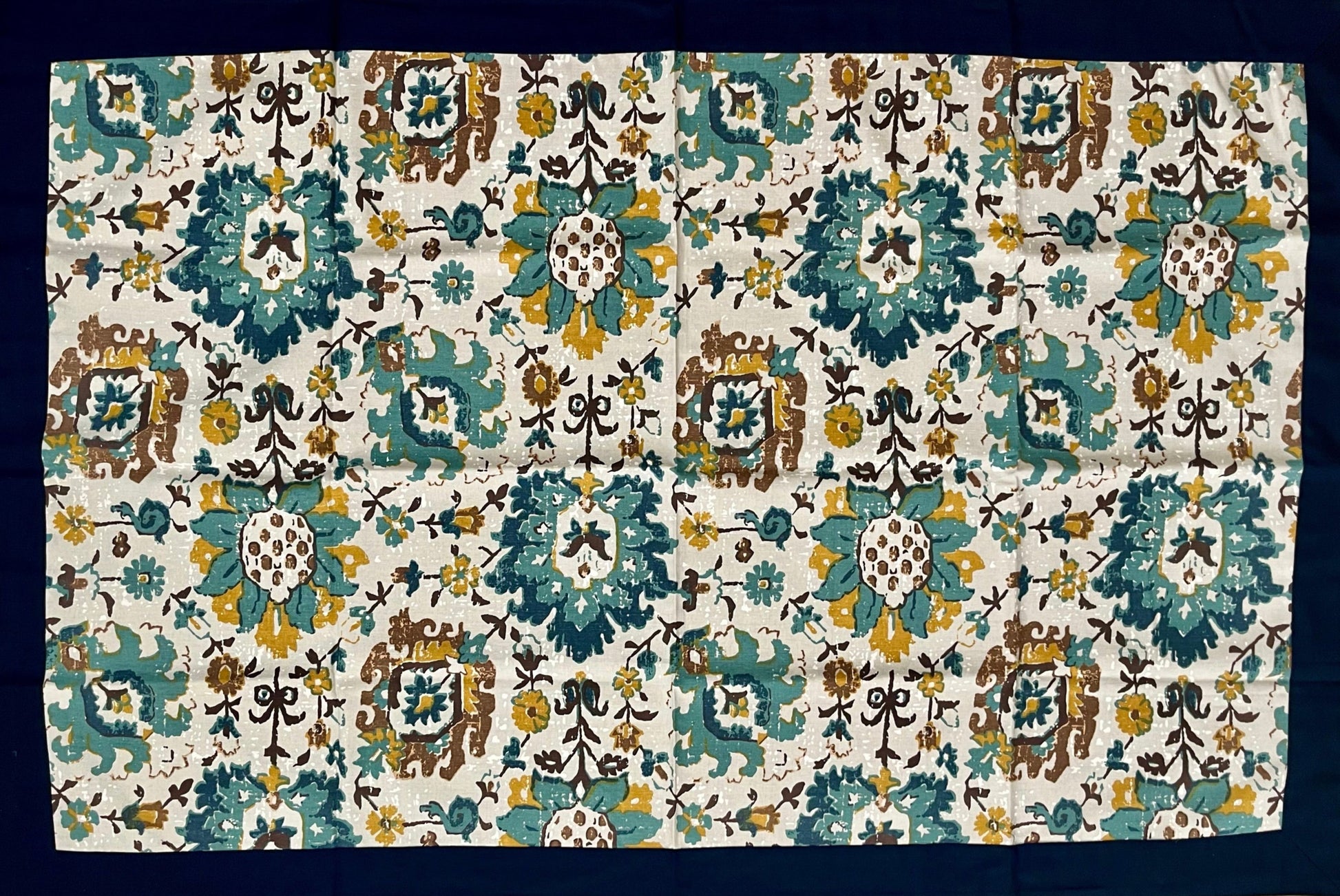 Floral cotton table cover featuring a teal, mustard, and white design, perfect for adding a vibrant touch to any dining space