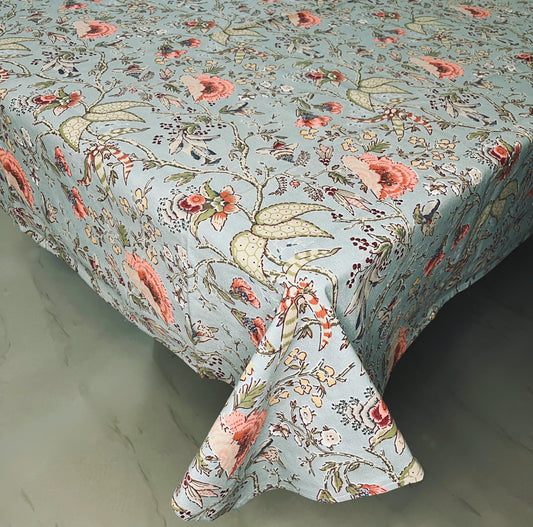 Floral dining tablecloth with a vintage botanical print in blue-green, featuring coral flowers