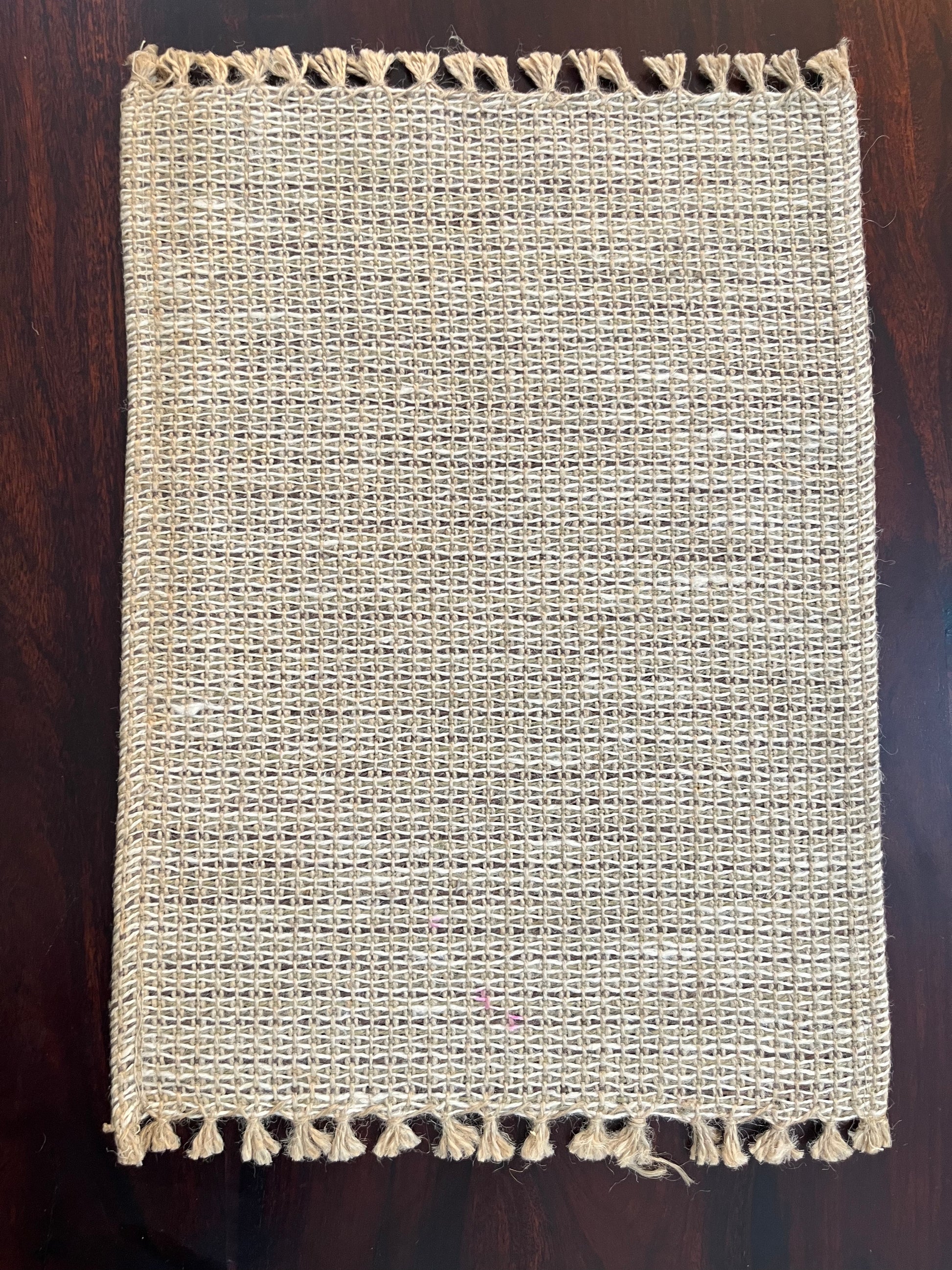 Set of 6 natural jute placemats featuring a woven design with fringe, perfect for rustic and boho table settings
