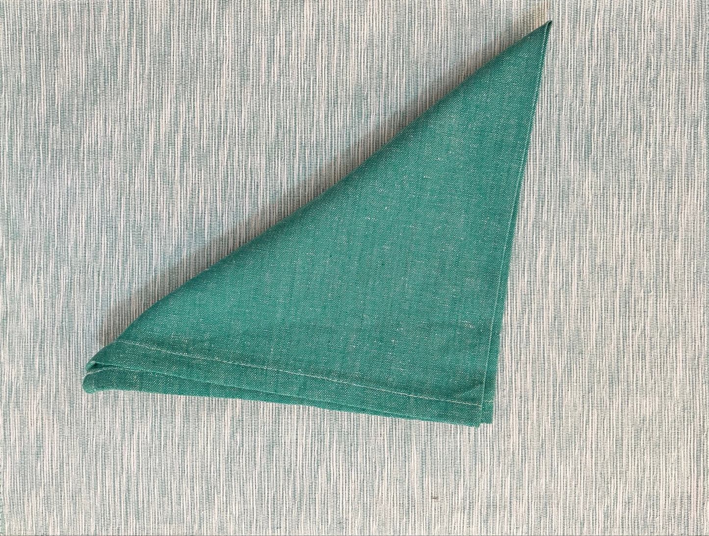Set of 6 placemats and napkins featuring a teal green woven design, perfect for elegant and coordinated table settings