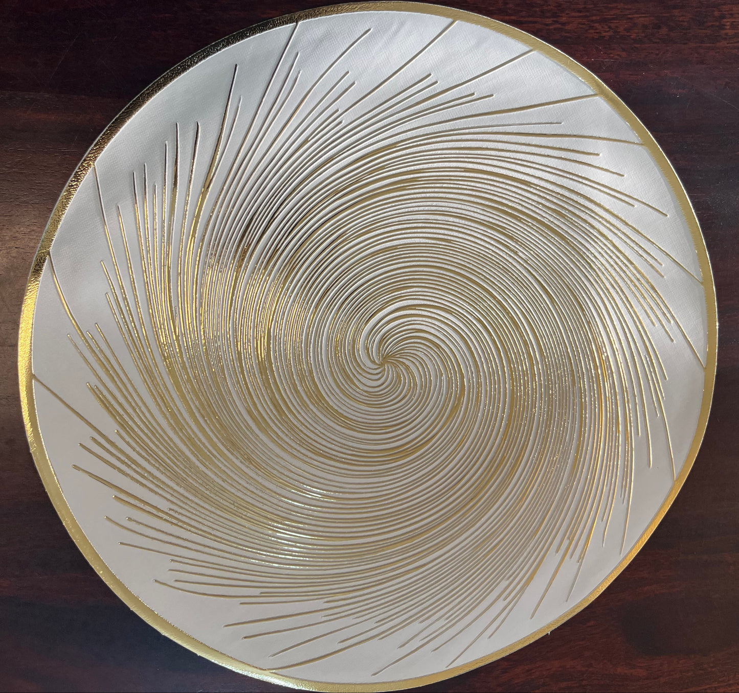 Set of 6 round PVC placemats featuring a golden spiral design, perfect for elegant dining décor