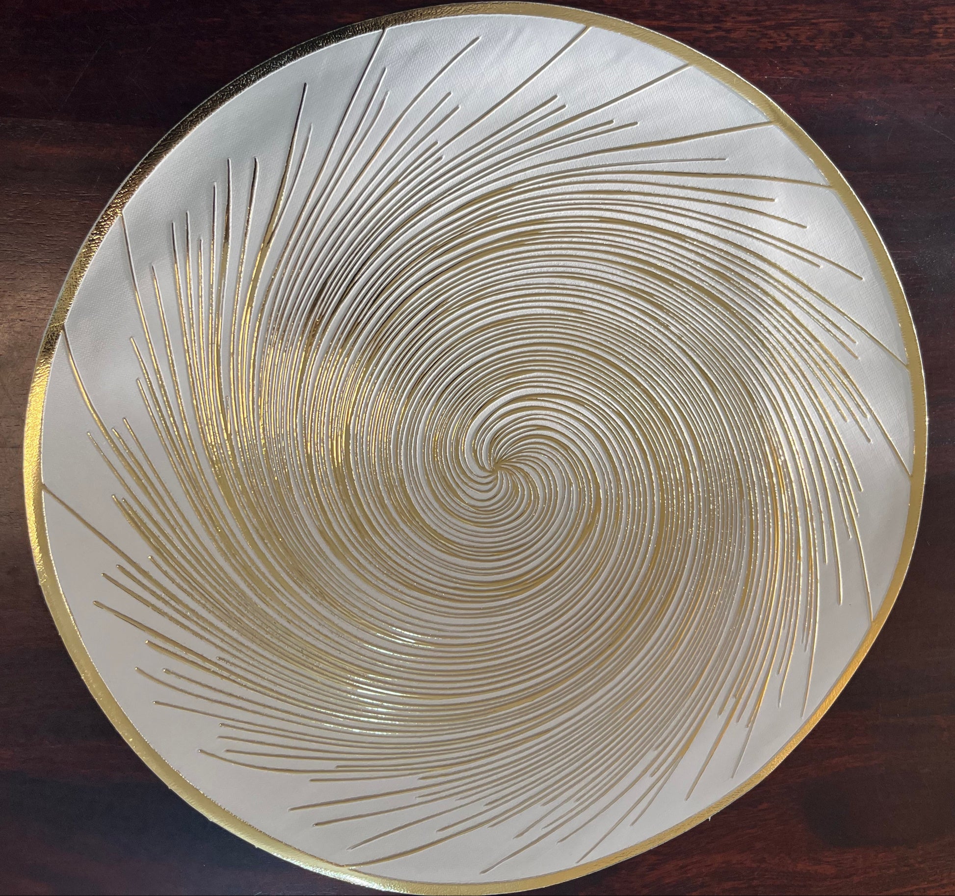 Set of 6 round PVC placemats featuring a golden spiral design, perfect for elegant dining décor