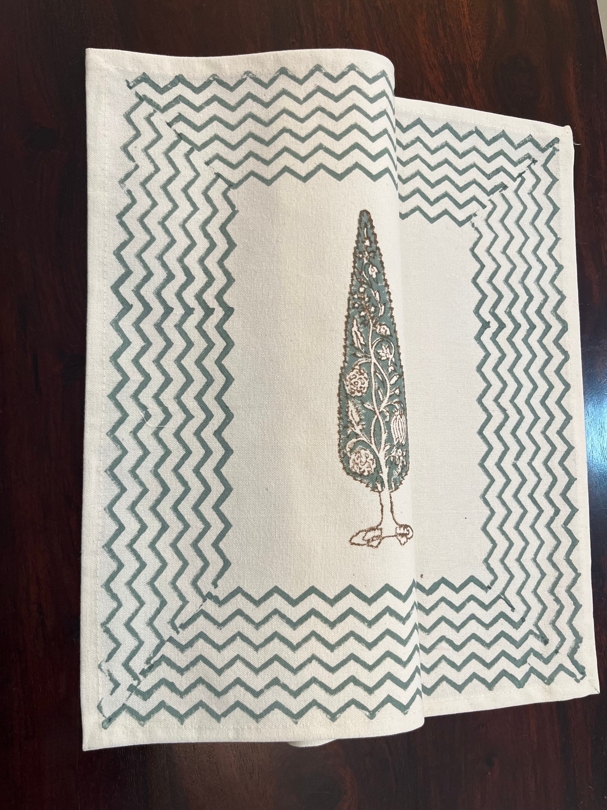 Dining table setup featuring block-printed table mats with a cypress tree motif for a timeless and elegant look