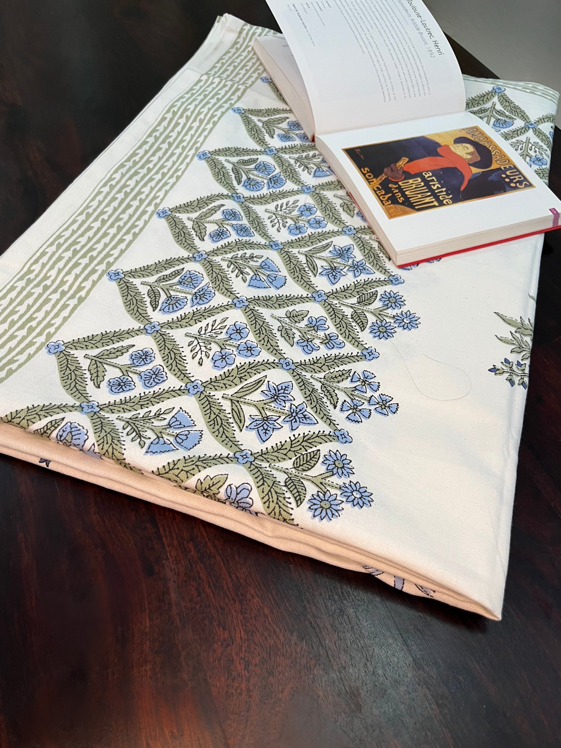 Beautifully styled dining table featuring a floral block print cotton tablecloth with a traditional blue and green design