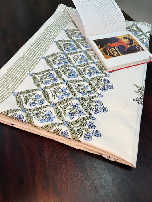 Beautifully styled dining table featuring a floral block print cotton tablecloth with a traditional blue and green design