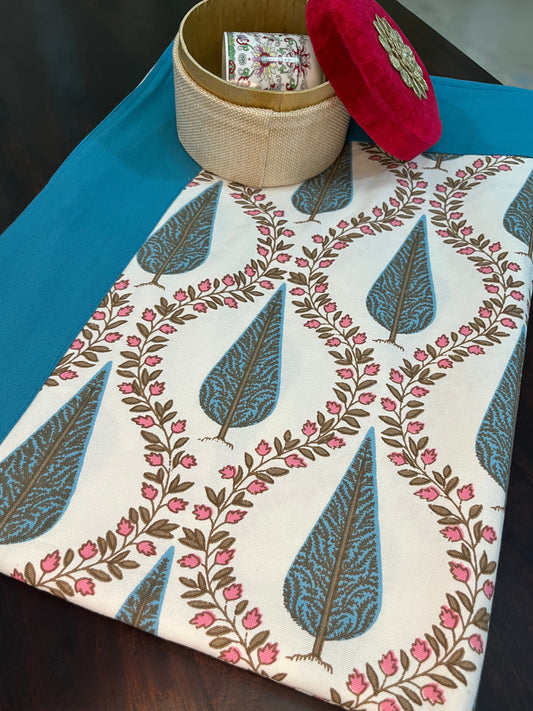 Beautifully styled dining table with a floral block print cotton table cover in blue and white with pink flowers and a turquoise border