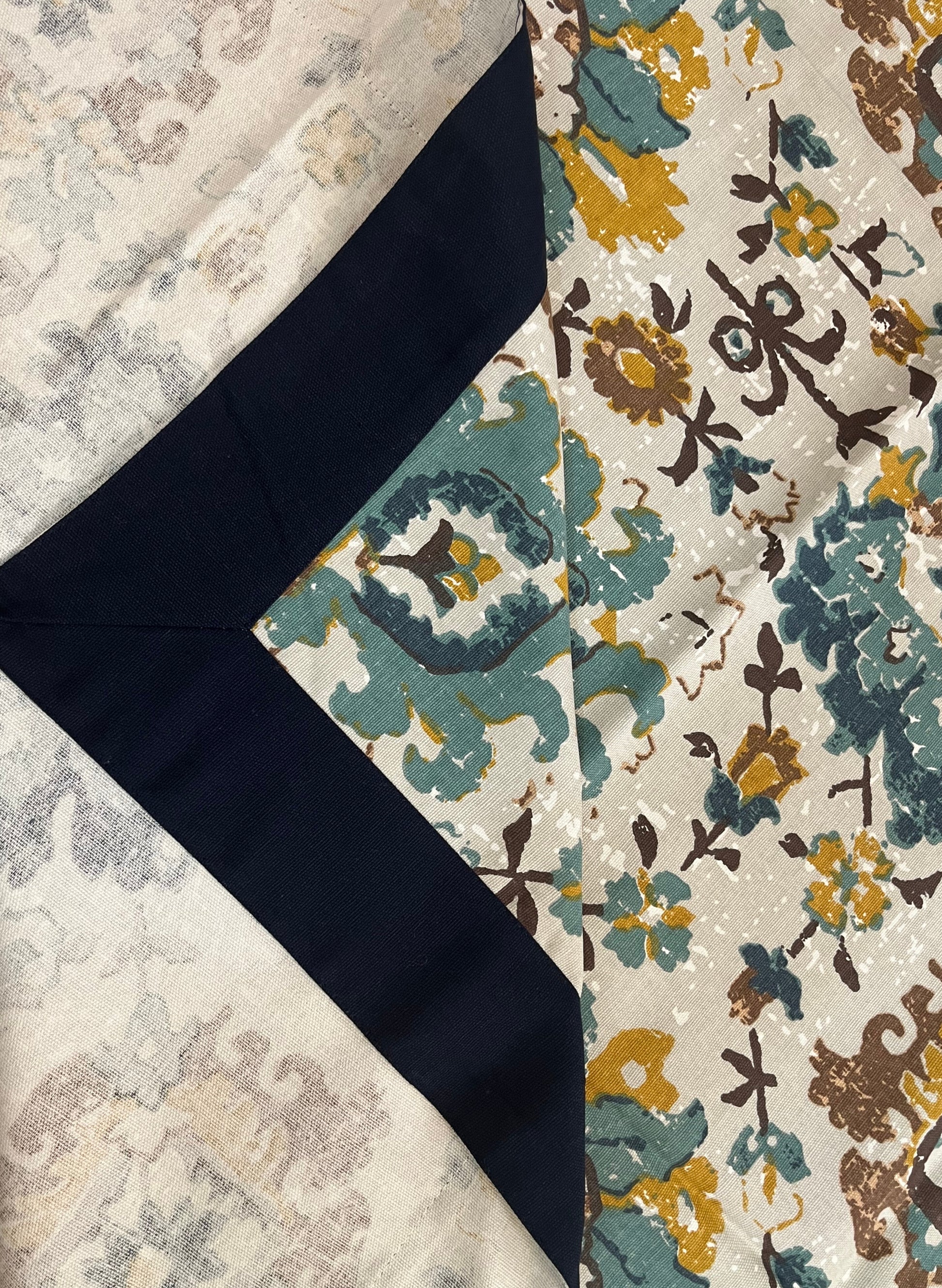 Dining table setup featuring a floral cotton table cover in teal, mustard, and white for an elegant and cozy look
