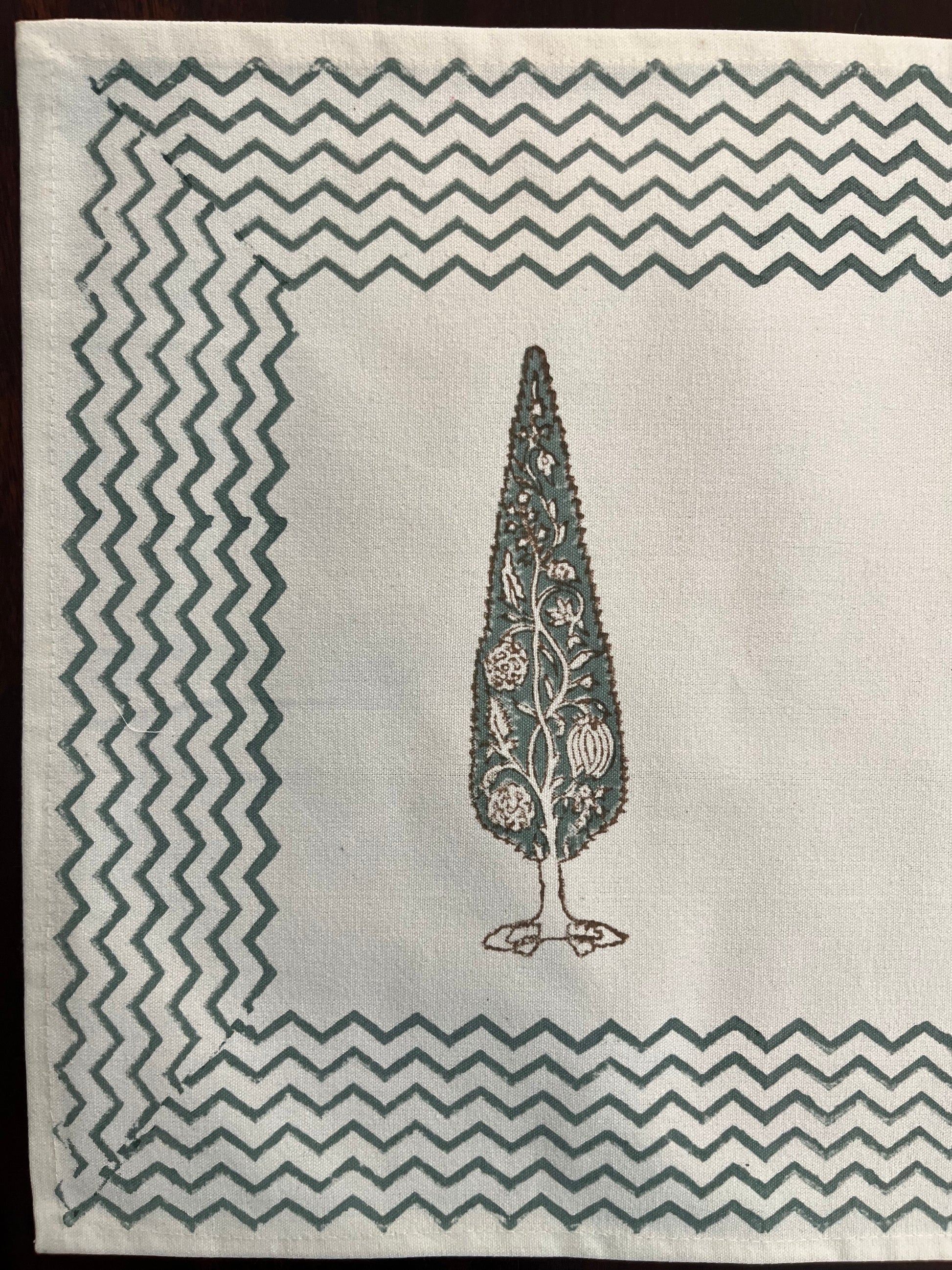 Close-up of block-printed table mat showcasing intricate cypress tree motif with fine detailing