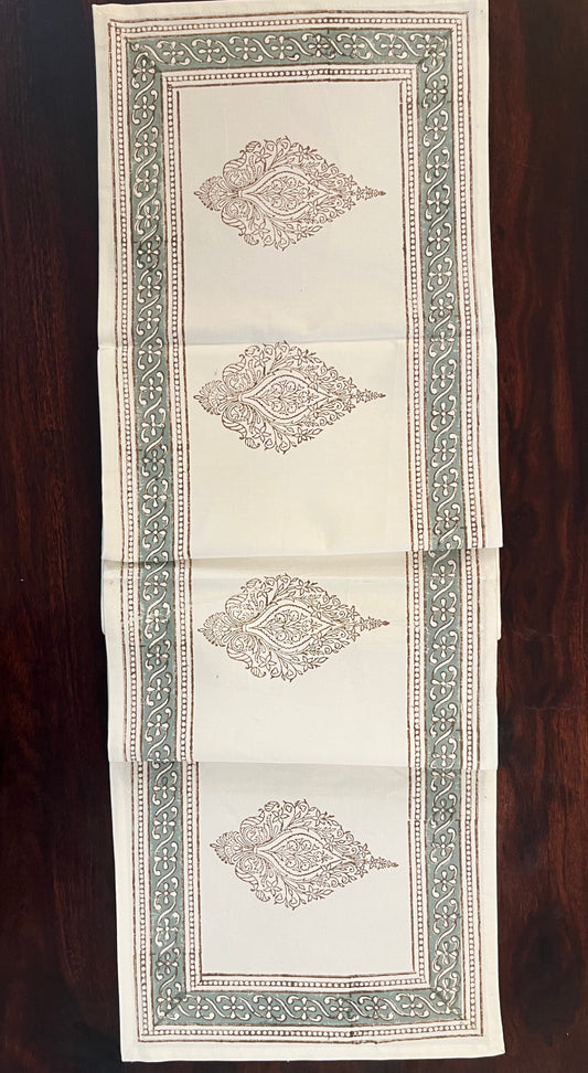 Close-up of decorative table runner showcasing an artisanal block print design with fine details