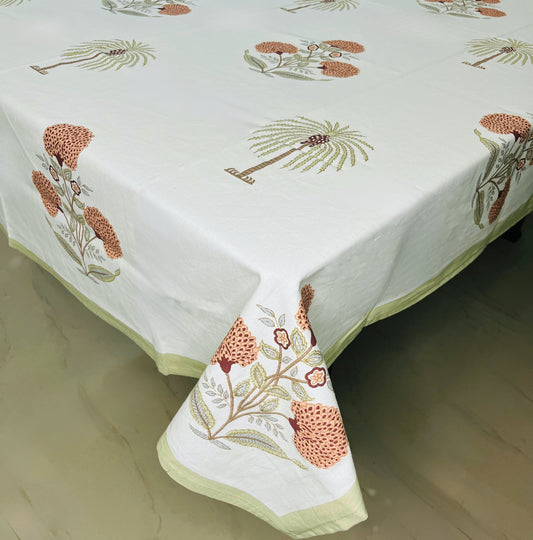 Tropical palm and floral print dining tablecloth in white with a stylish green border
