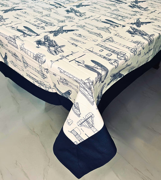Vintage aircraft print dining table cover for a 6-seater, featuring a navy blue border and cream background with an aviation design