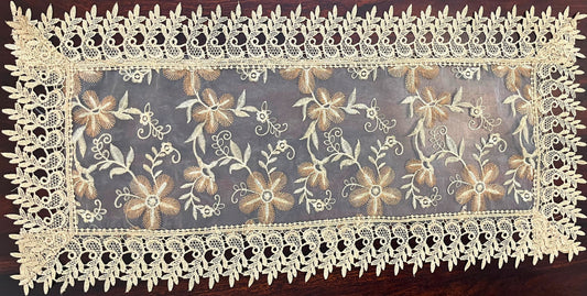 Small vintage lace table runner featuring an intricate floral design, perfect for adding elegance to any table setting